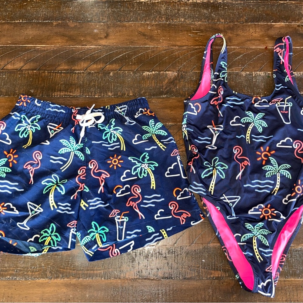 His and hers small Chubbies One Piece Swim in Blue and Pink with Tropical Print